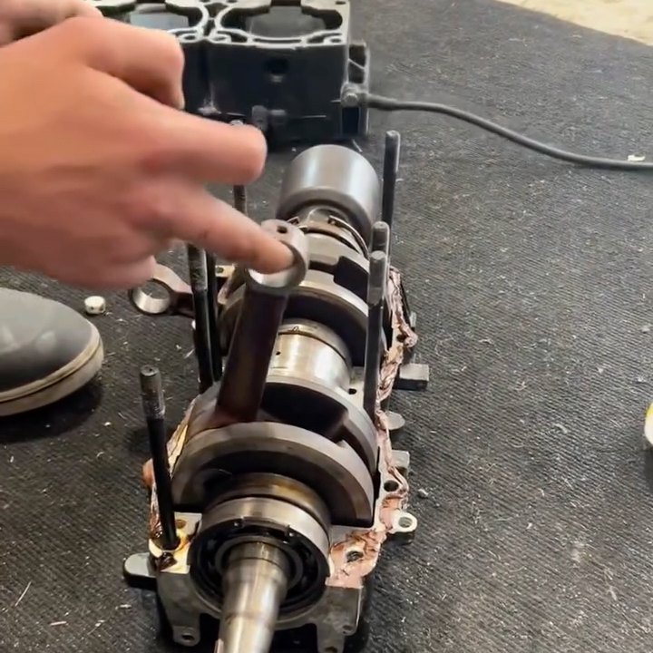 A crankshaft lifted out of split engine cases